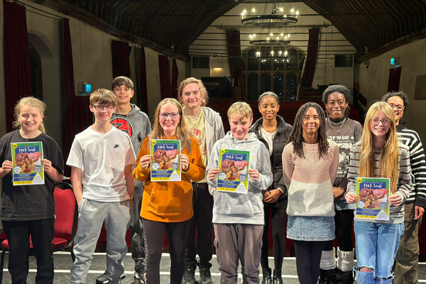 Group of young people holding up posters