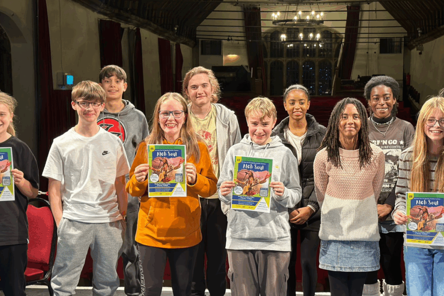 Group of young people holding up posters